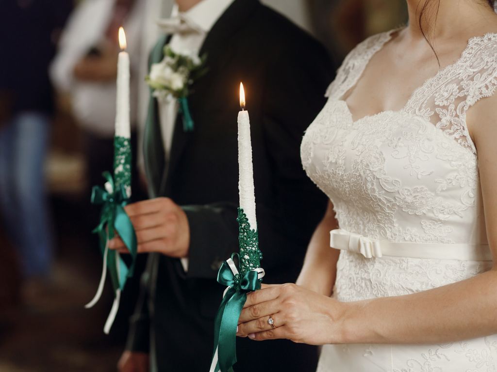 casal de noivas com duas velas nas mãos