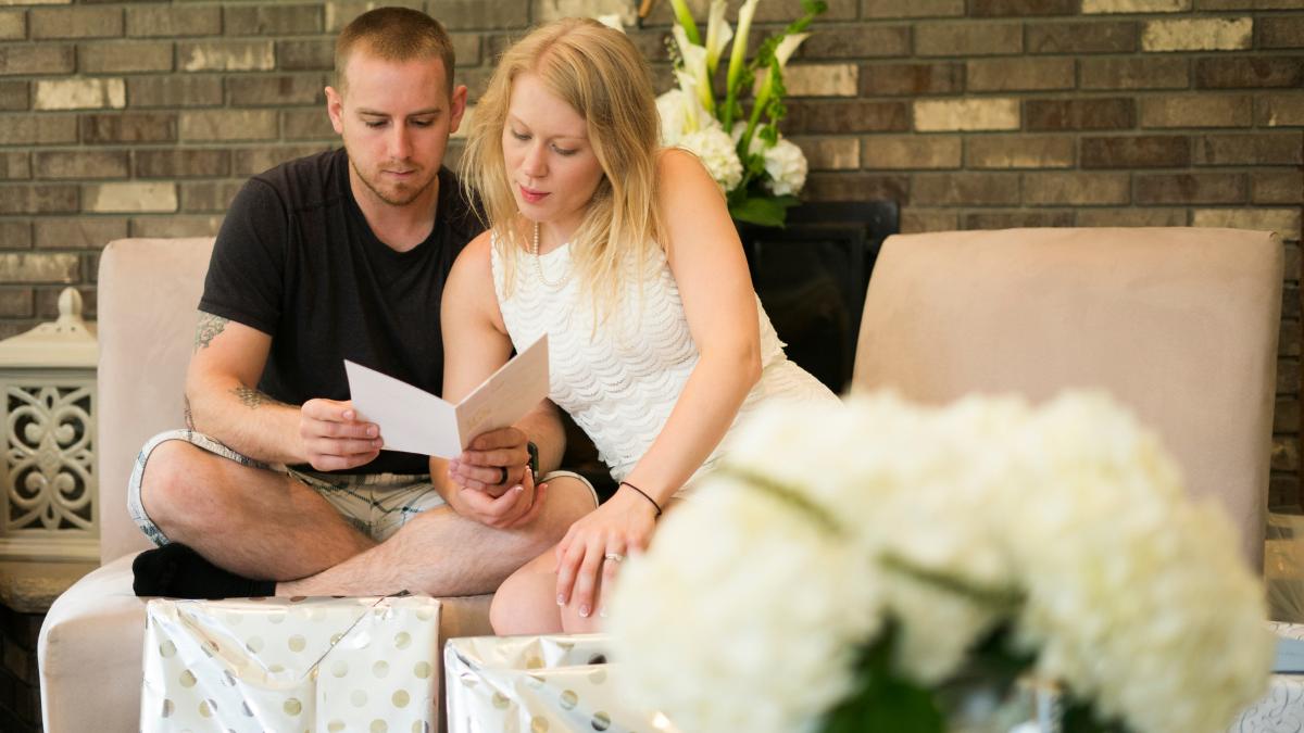 Casal vendo o que recebeu de sua lista de presente de casamento.